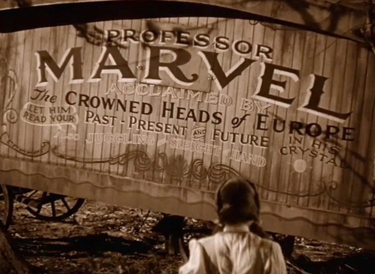 Dorothy watches Professor Marvel’s wagon in a scene from The Wizard of Oz.